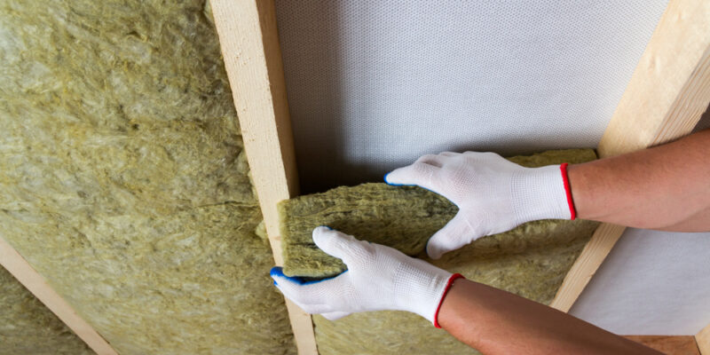 Close-up,Of,Worker,Hands,In,White,Gloves,Insulating,Rock,Wool